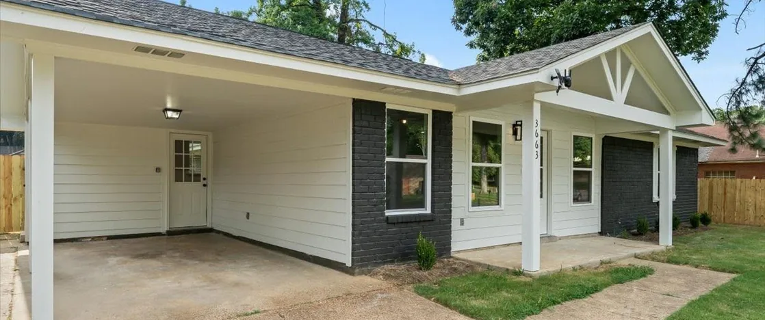 The same house finished, with a new porch and carport
