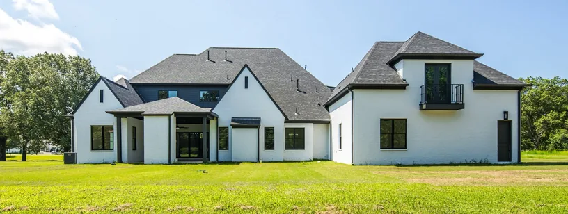 A finished home seen from the garden, across the lawn