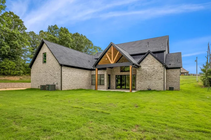 A second completed home, dark board and batten